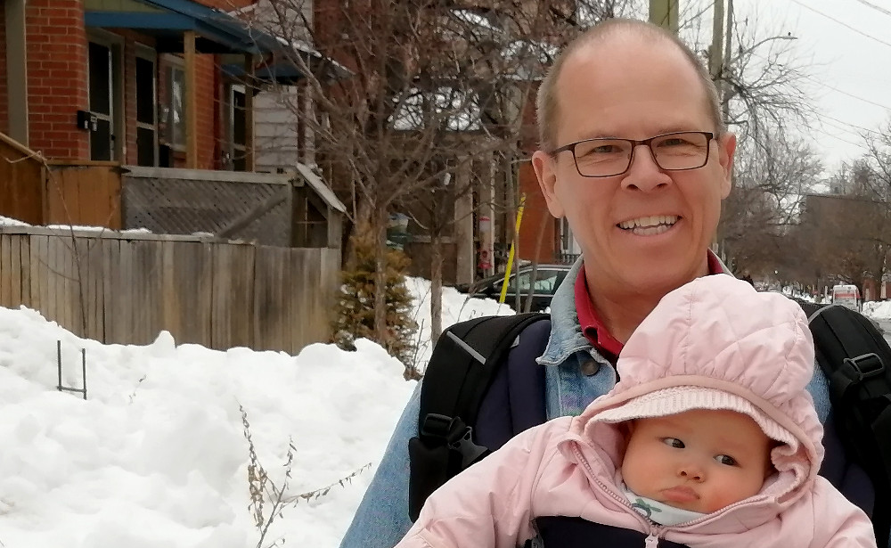 Photo of Papa Zesser carrying Asta in a snuggly.