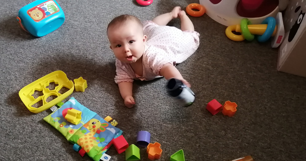 Photo of baby on floor with toys.