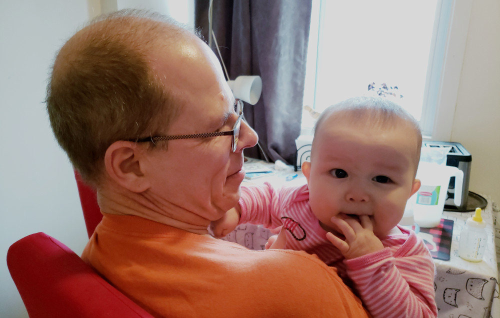 Photo of Papa Zesser holding Baobao the day after she suffered from teething