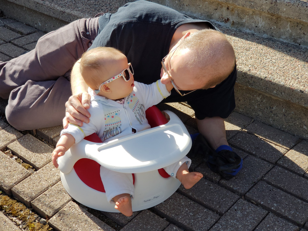 Photo of Papa Zesser with Baobao on steps outdoors