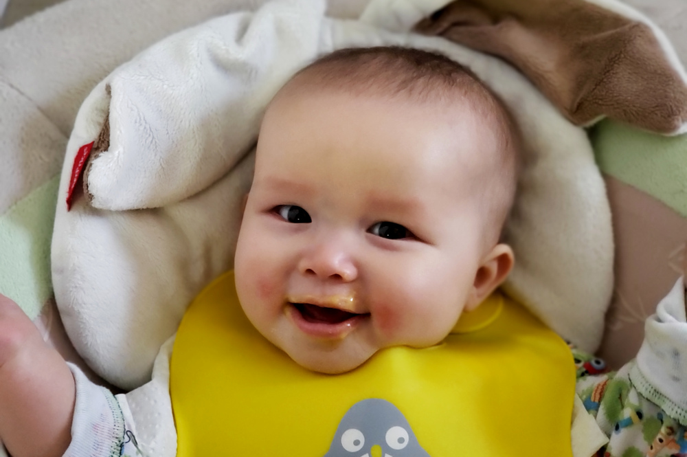 Photo of happy baby with lips surrounded by delicious food!