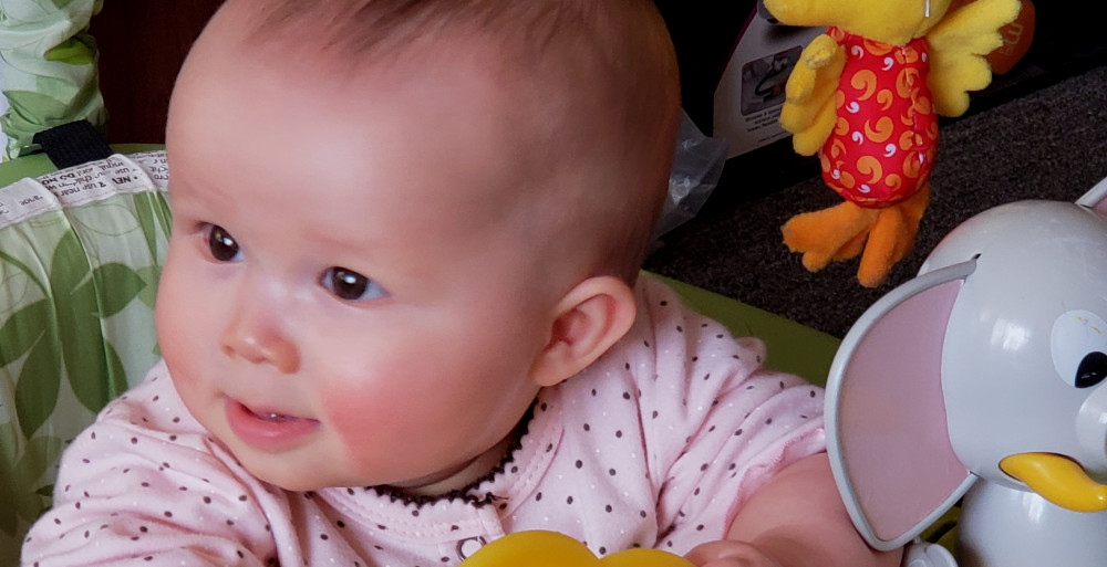 Close-up photo of smiling baby.