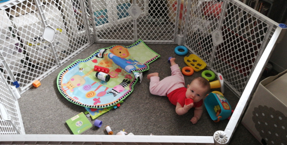 Photo of baby playing in 6-sided playpen.