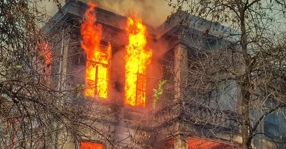 Detail of photo of building in flames by Chris Karidis via Unsplash.