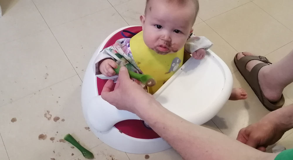 Phobo of Baby Baobao attempting to self-feed.