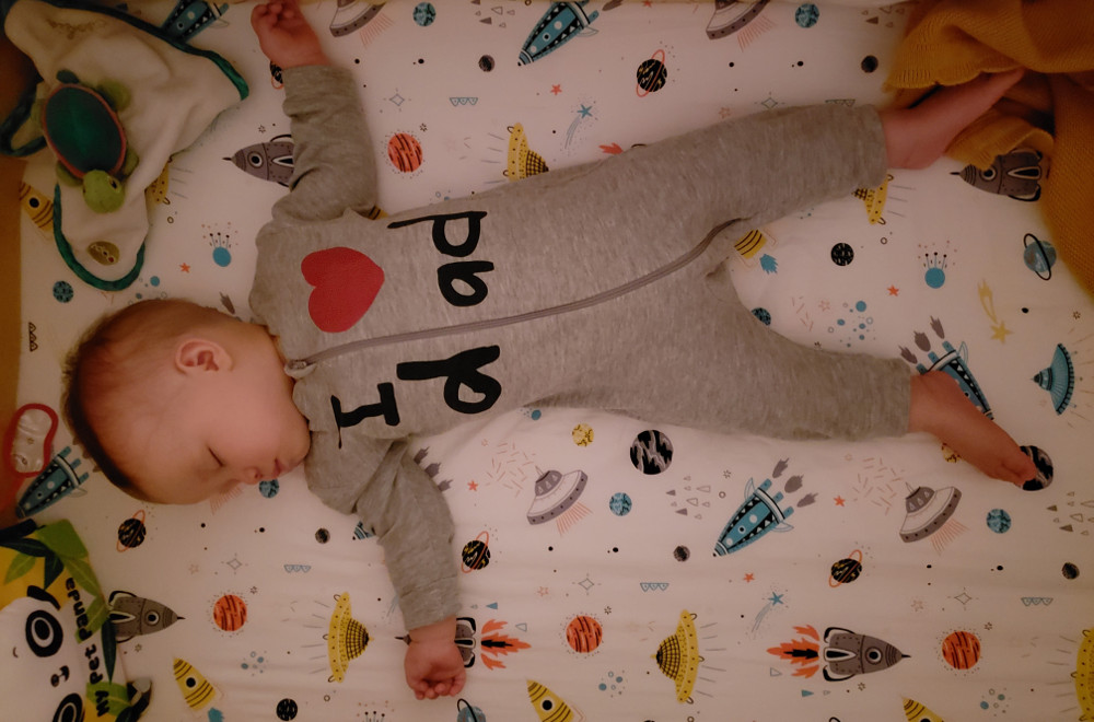 Photo of Bay Baobao asleep with onesy reading 'I Heart dad" on the night of August 21, 2020.