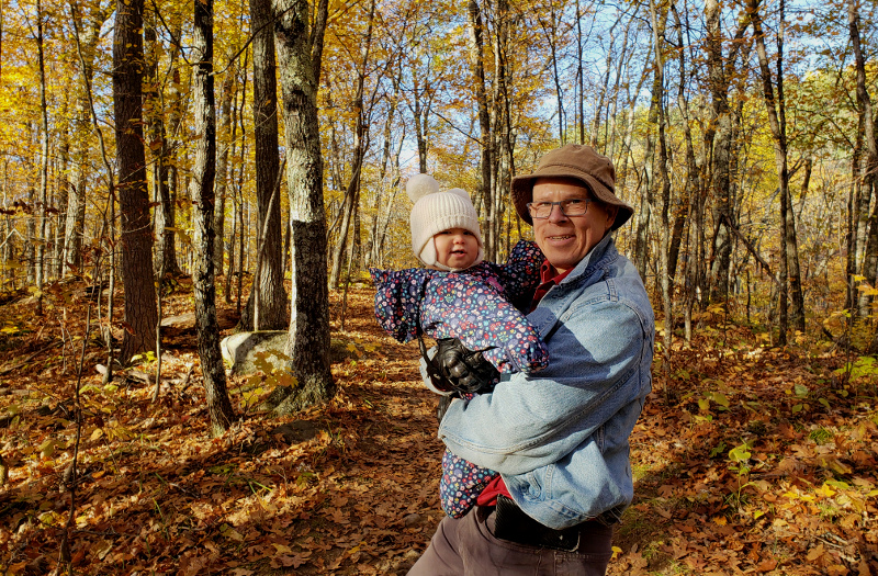 Photo of Papa Zesser holding baby Baobao while hiking through Parc Mont-Morisset