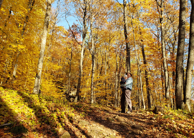 Photo of Papa Zesser carrying baby Baobao up a steep trail in Parc Mont-Morrissette, Quebec.