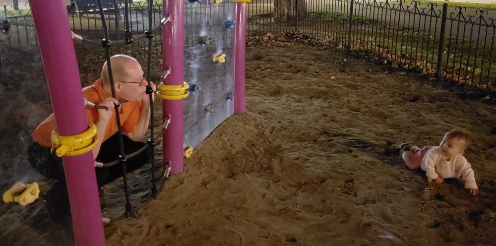 Photo of Papa Zesser and Toddler Baobao at a park after sunset.